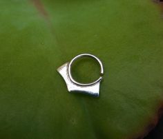 Geometric silver hoop ring- tribal boho piercing ~ Can be used as a nose ring / septum / tragus / single earring / helix / lip ring ~ Size of the nose ring: Inner diameter : 1/4, 5/16 or 3/8 inch (7,8 or 9 mm) Wire gauge : 24,22,20,18 or 16 (0.5, 0.6, 0.8, 1 or 1.2 mm) ~ For larger sizes and special requests please contact me through the' Request custom order' bar. ~To open the ring -gently twist the ends sideways, slip into the hole and then gently twist the ends back for a continuous hoop. ~ Y Silver Open Ring Septum As Gift, Silver Open Ring Septum Gift, Handmade Silver Minimalist Nose Rings, Adjustable Silver Toe Ring Piercings, Handmade Minimalist Silver Nose Rings, Tiny Silver Minimalist Septum Ring, Dainty Adjustable Silver Septum Ring, Handmade Minimalist Silver Septum Ring, Dainty Tiny Silver Septum Ring