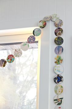 a window sill with buttons hanging from it's side and on the wall