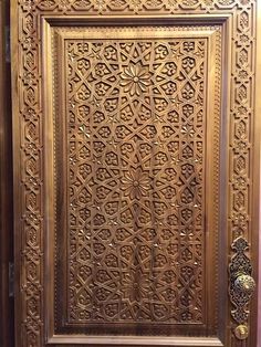 a wooden door with intricate carvings on it