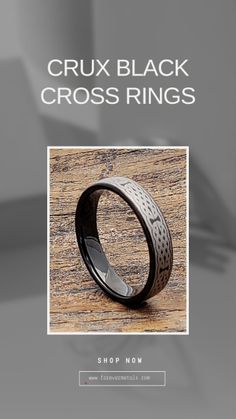 a black ring with an intricate design on it and the words, crux black cross rings