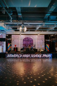 an empty dance floor with disco balls and lights on the wall in front of it