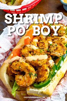 the shrimp po boy sandwich is sitting on top of wax paper