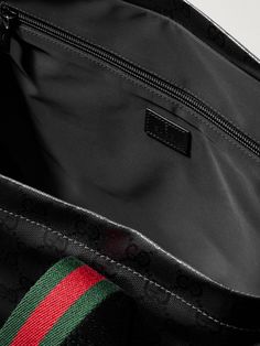 Crafted in Italy, Gucci's tote is made from coated-canvas detailed with the house's iconic monogram. It's fully lined in easy-to-clean shell and has enough space for a laptop and a change of clothes. The signature red and green webbing straps really pop against the sleek black background. Gucci Bag In Signature Coated Canvas, Gucci Rectangular Bag In Signature Coated Canvas, Gucci Rectangular Signature Coated Canvas Bag, Designer Leather Bags With Lined Interior, Gucci Black Shoulder Bag With Top Carry Handle, Designer Gucci Bags In Signature Coated Canvas, Designer Tote Bag With Lined Interior, Designer Rectangular Shoulder Bag With Lined Interior, Luxury Tote Bag With Lined Interior