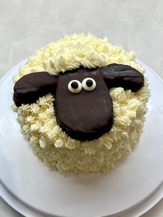 a cake decorated to look like a sheep with googly eyes