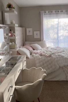 a bedroom with a bed, desk and chair in it's centerpieces