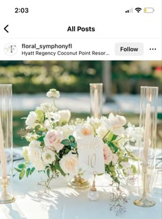 a table with flowers and candles on it