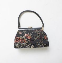 an embroidered purse hanging on the wall