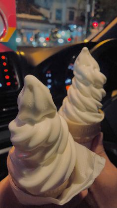 two ice cream cones sitting on top of each other in front of a steering wheel