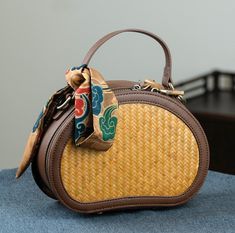 This exquisite handbag is meticulously handcrafted, combining fashion with tradition. Made from natural bamboo, fabric, and high-quality microfiber leather (non-animal leather), it features a durable metal zipper. Utilizing traditional Chinese craftsmanship, each bag is uniquely crafted to perfection, ensuring no two pieces are exactly alike. This bag seamlessly merges modern style with timeless techniques, offering a unique and elegant accessory for any occasion. Beige Leather Shoulder Bag With Bamboo Handle, Brown Shoulder Bag With Bamboo Handle, Brown Crossbody Straw Bag With Bamboo Handle, Brown Satchel With Bamboo Handle For Travel, Travel Brown Satchel With Bamboo Handle, Brown Travel Bags With Bamboo Handle, Travel Satchel With Bamboo Handle In Brown, Brown Handheld Shoulder Bag With Bamboo Handle, Brown Shoulder Bag With Bamboo Handle For Daily Use