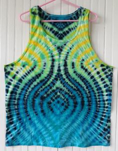 a tie - dyed tank top hanging on a wall