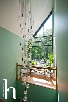 a chandelier hanging from the ceiling in front of a window