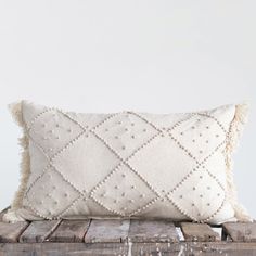 a white pillow sitting on top of a wooden crate