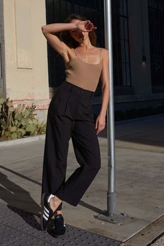 Solid-color pants. Pegged straight leg with buttoned cuff. Hip pockets. Pleated front with seam detail. Concealed waist closure and zip-up fly. Belt loop waistband. High waist. Relaxed fit. 100% Polyester. Imported. Designed in LA. Model wears size S. Peg Pants, Vision Statement, Color Pants, Solid Color Pants, Vintage Canvas, Zip Up, Zip Ups, High Waist, Straight Leg