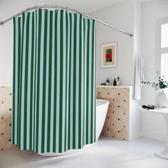 a green and white striped shower curtain in a bathroom