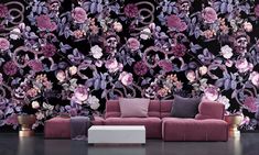 a living room with purple flowers on the wall