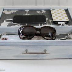 an open suitcase with sunglasses and other items in it