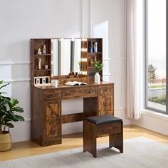 a wooden desk with a mirror and stool in front of a large window next to a potted plant