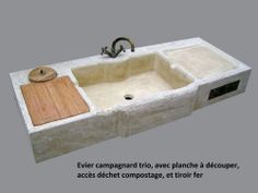 the sink is made out of concrete and has a wooden cutting board on top of it