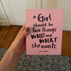 a person holding up a pink card with the words, a girl should be two things who and what she wants