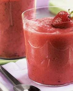 two glasses filled with smoothie on top of a table