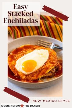 an egg is sitting on top of some food in a bowl with the words easy stacked enchiladas