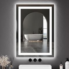 a white sink sitting under a bathroom mirror next to a wall mounted faucet