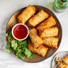 some fried food on a plate with dipping sauce and parsley next to the plate