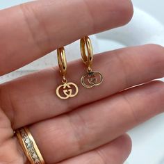 14k Solid Gold Huggie Earrings with Dangle Double G Overlay, 14k Solid Yellow Gold Double Interlock G Huggie Earrings. - Earrings Size:Length: 20mm | Drop Length: 6mm | Width: 2mmDrop Width: 8mm | Thickness: 2mm Luxury Huggie Earrings For Gift, Luxury Huggie Earrings As Gift, Luxury Dangle Huggie Earrings, Luxury Hinged Huggie Earrings As Gift, Luxury Handmade Huggie Jewelry, Gold Huggie Earrings, Gold Huggies, Anklet Bracelet, Huggie Earrings