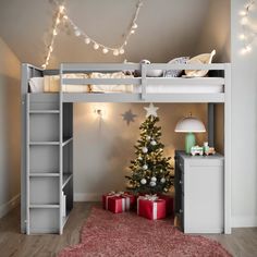 there is a bunk bed with a christmas tree in the corner