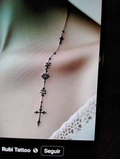 an image of a woman's chest with a cross on the back of it