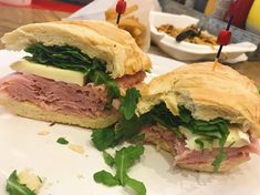 a cut in half sandwich sitting on top of a white plate