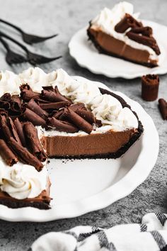 a slice of chocolate pie on a plate with whipped cream and chocolate shavings