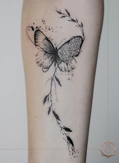 a woman's leg with a butterfly tattoo on the left side of her thigh