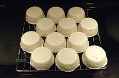 there are many white cakes on the cooling rack