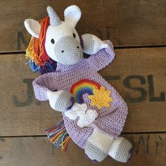 a crocheted stuffed animal with a rainbow on it's chest