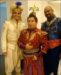 three men in costume posing for a photo