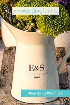 a white vase filled with flowers on top of a table