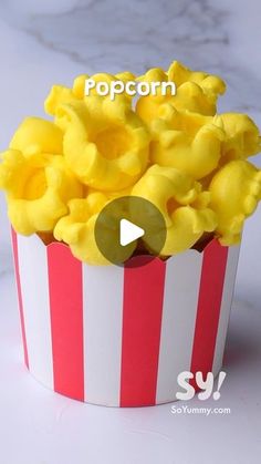 popcorn in a red and white striped box with the word popcorn on it's side