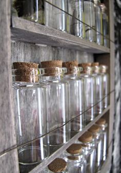 several glass jars are lined up on the wall