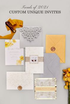 the wedding stationery is displayed with yellow flowers