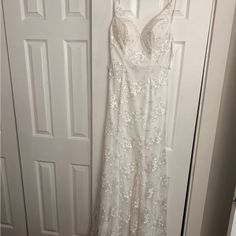 a white dress hanging on a door