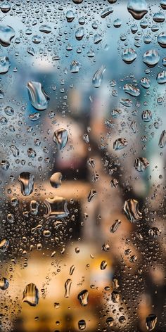 rain drops on the window with people in the background