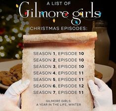 a list of gilmore girls christmas episode written on a piece of parchment paper in front of a plate of cookies