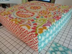 a colorful table cloth is sitting on the floor