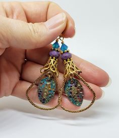 Hand-Painted Earrings. The centerpiece of these earrings are the beautiful hand-painted on copper with resin charms made by Washington State artist Kristi. I accented them with rounded triangle connectors, vintage brass bead caps, purple faceted Czech glass beads and turquoise Swarovski crystal bicone beads. These earrings are 3 inches long including the pure brass round lever back closures. One Of A Kind I can send it gift wrapped (free of charge), if requested. Handmade Bronze Czech Glass Earrings, Bohemian Gold Resin Earrings, Bohemian Resin Jewelry With Matching Earrings, Bohemian Nickel Free Teardrop Clip-on Earrings, Bohemian Nickel-free Teardrop Clip-on Earrings, Bohemian Teardrop Nickel-free Clip-on Earrings, Bohemian Teardrop Nickel Free Clip-on Earrings, Handmade Bronze Brass Teardrop Earrings, Unique Handmade Teardrop Clip-on Earrings