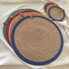 four round placemats on top of a white sheet