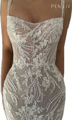 the back of a woman's dress with white flowers on it and an open neckline