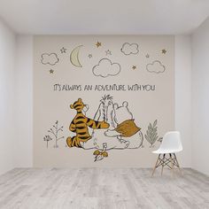 winnie the pooh and tigger wall mural in an empty room with white chairs