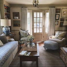 a living room with two couches and a coffee table in front of a door