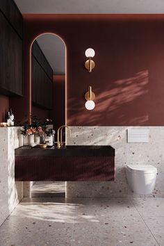 a bathroom with a sink, toilet and mirror on the wall next to each other